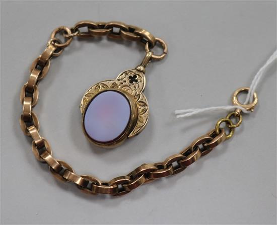 An early 20th century 10ct gold, bloodstone and carnelian spinning fob seal on a yellow metal bracelet.